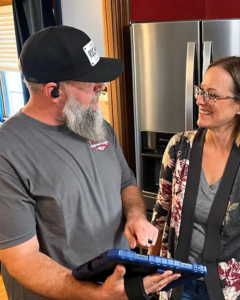 Our owner showing a homeowner the diagnosis and price on a tablet before any work starts
